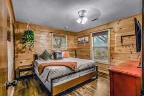 A bedroom with a bed, a bedside table, a hanging plant, a window, and a ceiling fan. - Your Home Away From Home 3 bedrooms, 2 bathrooms, 7 minutes to Pigeon Forge (Sevierville)