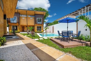 A modern two-story house with a swimming pool, outdoor seating, and a well-maintained garden. - Walk to Shops & Eats! Cozy Playas Del Coco Studio (Sardinal)