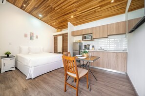 A modern bedroom with a bed, bedside table, and a small potted plant. - Walk to Shops & Eats! Cozy Playas Del Coco Studio (Sardinal)