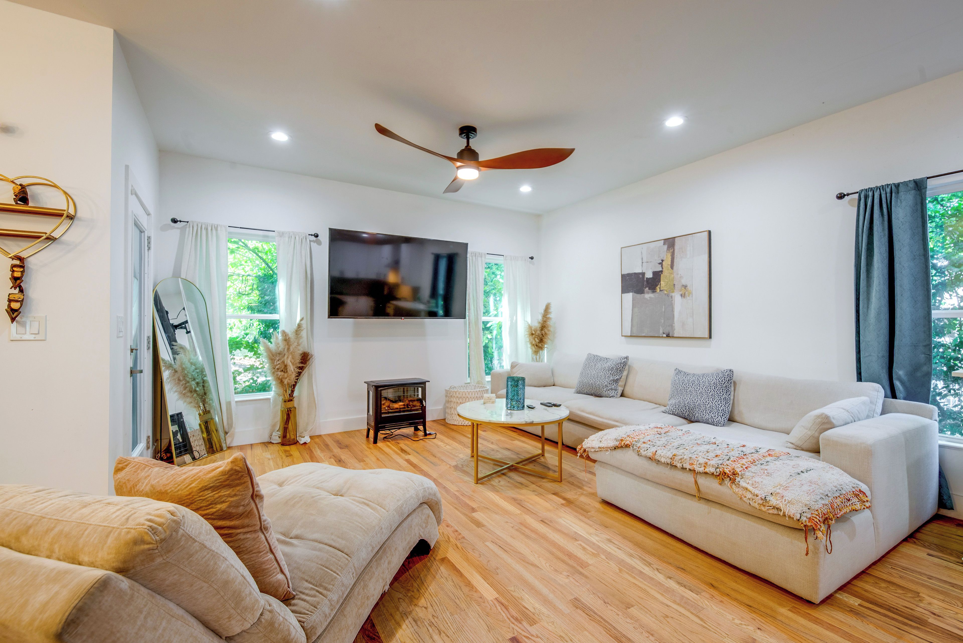 A modern living room with a sofa, a coffee table, and a television.