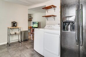 A compact kitchen with a washing machine, a coffee maker, and a refrigerator. - 5 Mi to Honky Tonk Hwy! Charming Escape w/ Porch (Nashville)