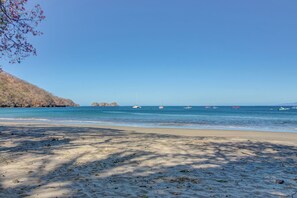 A beach with clear skies, calm waters, and boats. - Beach Access & Resort Perks: Playa Hermana Villa (Sardinal)