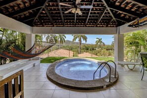 A pool area with a hot tub, a hammock, and a view of a mountainous landscape. - Beach Access & Resort Perks: Playa Hermana Villa (Sardinal)