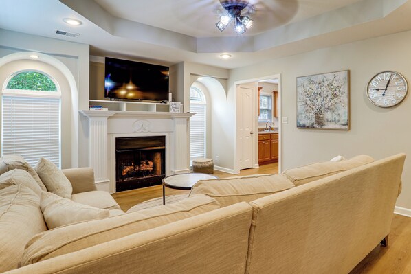 A living room with a fireplace, a television, and a sofa.