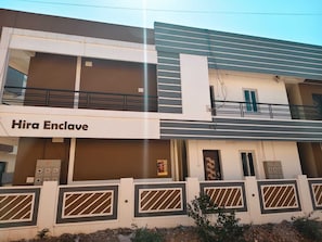 Un immeuble à plusieurs étages sur lequel on peut lire l’inscription « Hira Enclave ».