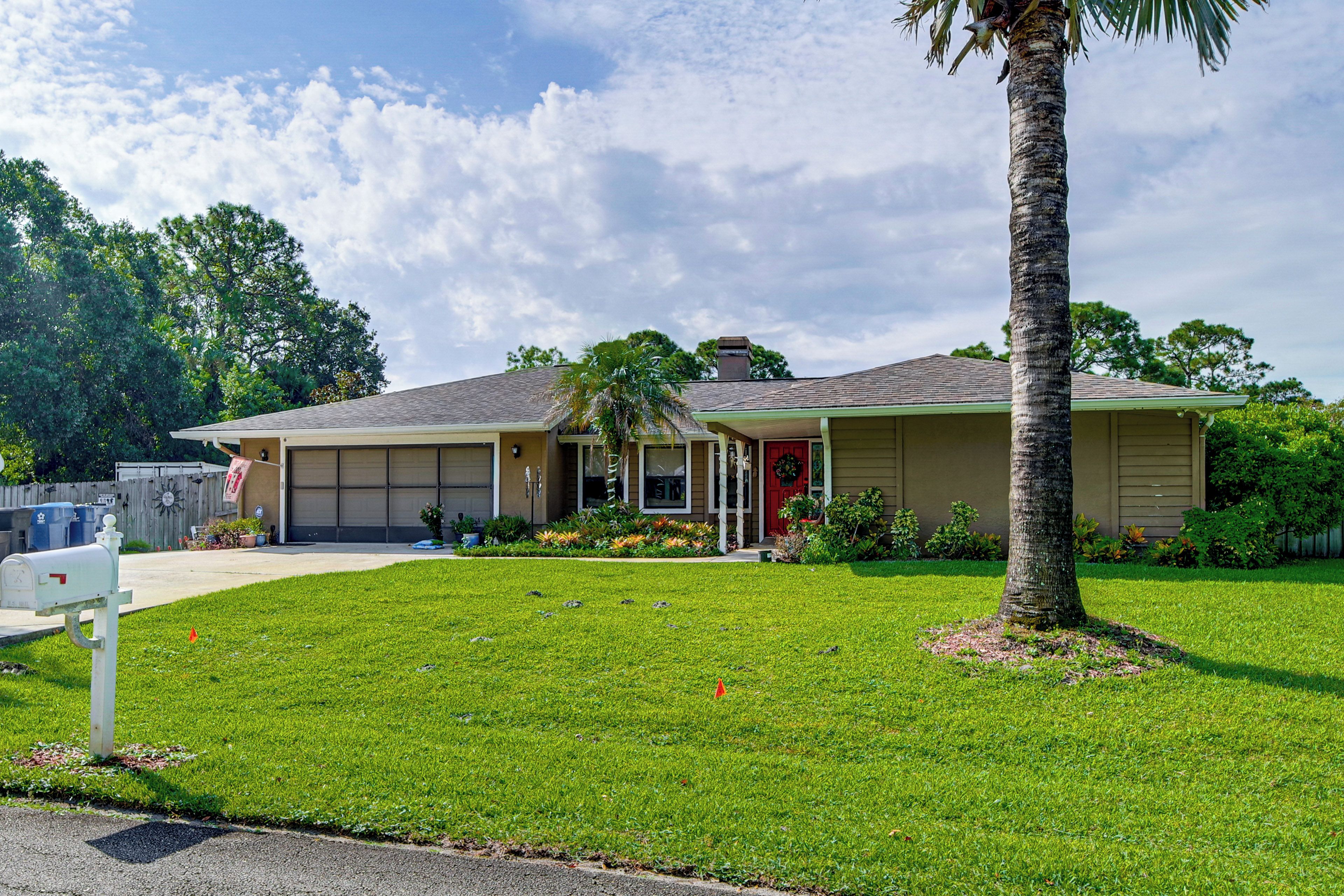 A single-story house with a garage, a front porch, and a well-maintained lawn.