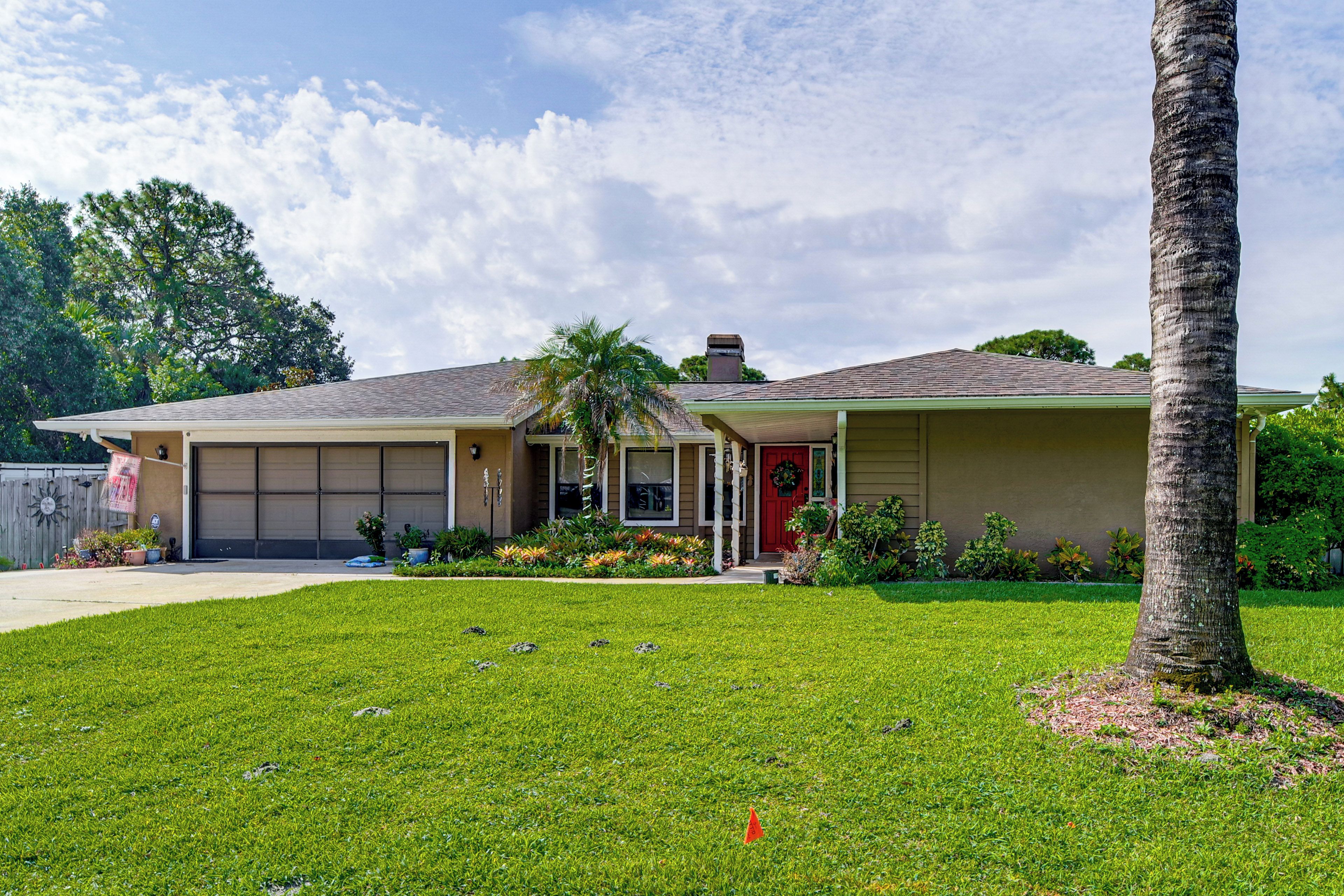 A single-story house with a garage, a front porch, and a well-maintained lawn.