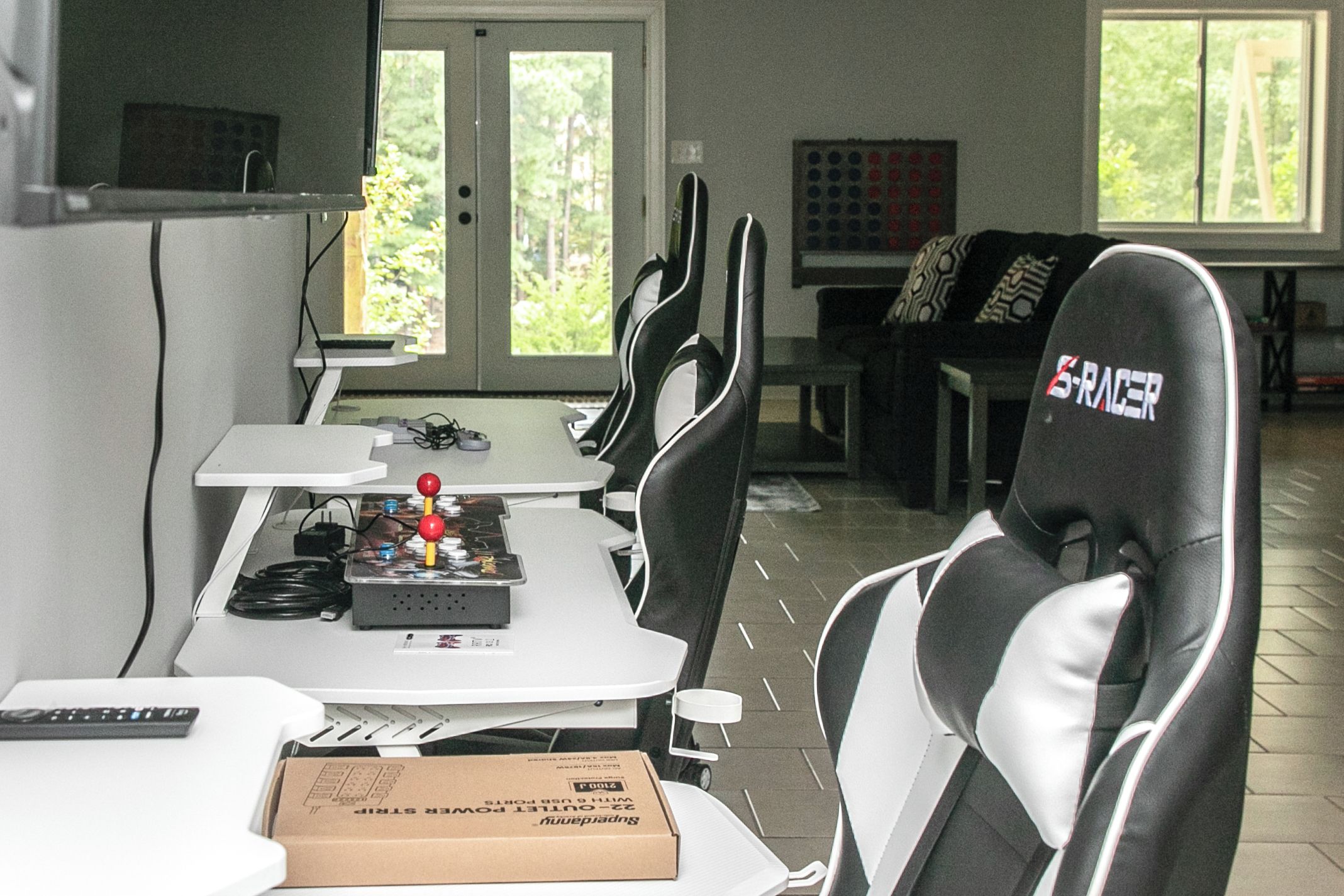 A dining area with a table, chairs, and a box on the table.
