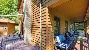 A covered outdoor deck with wooden flooring and blue cushioned chairs. - Fishing Dock & Sauna! Farmville Gem w/ Views (Farmville)