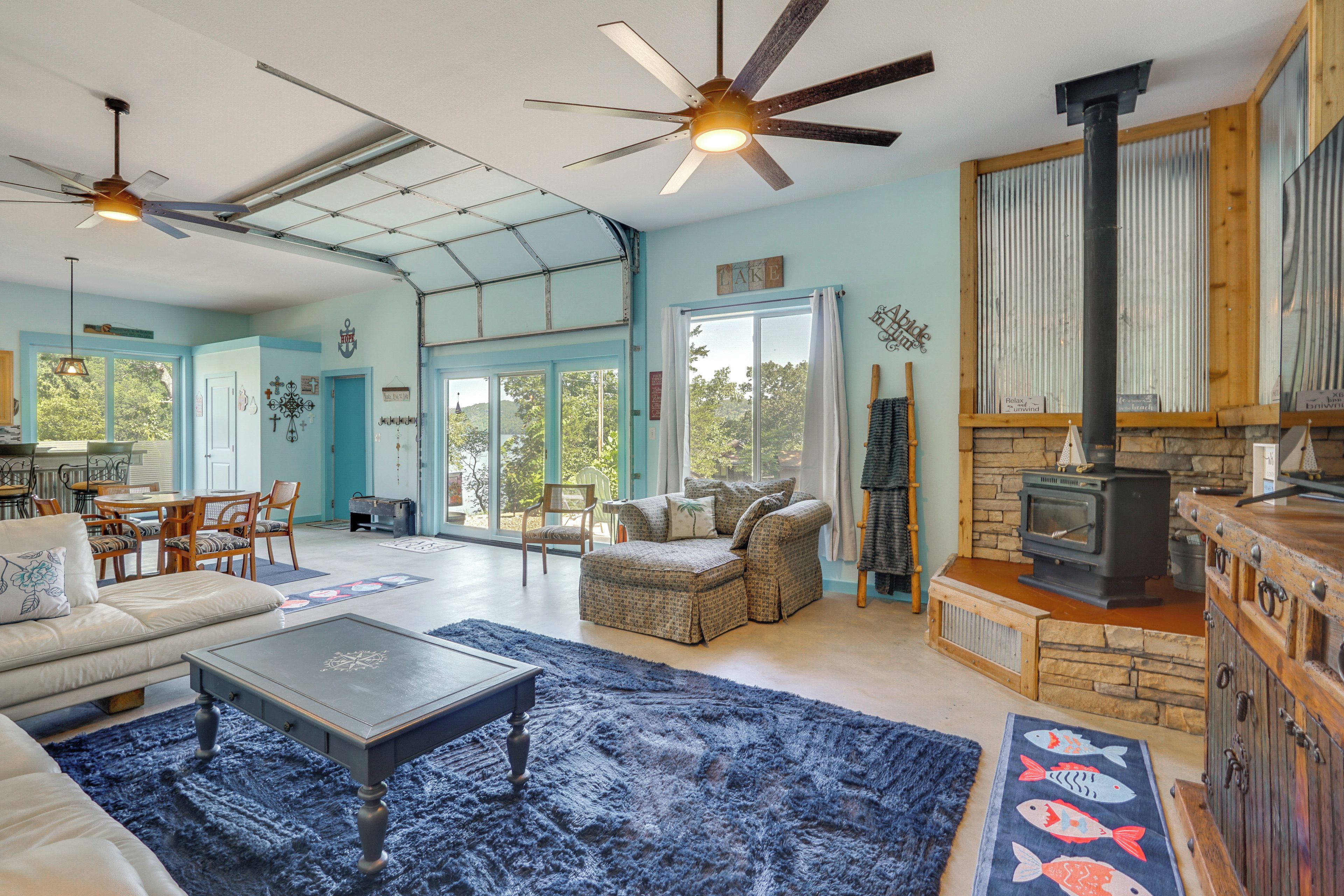 A spacious living room with a fireplace, a dining area, and a kitchen.