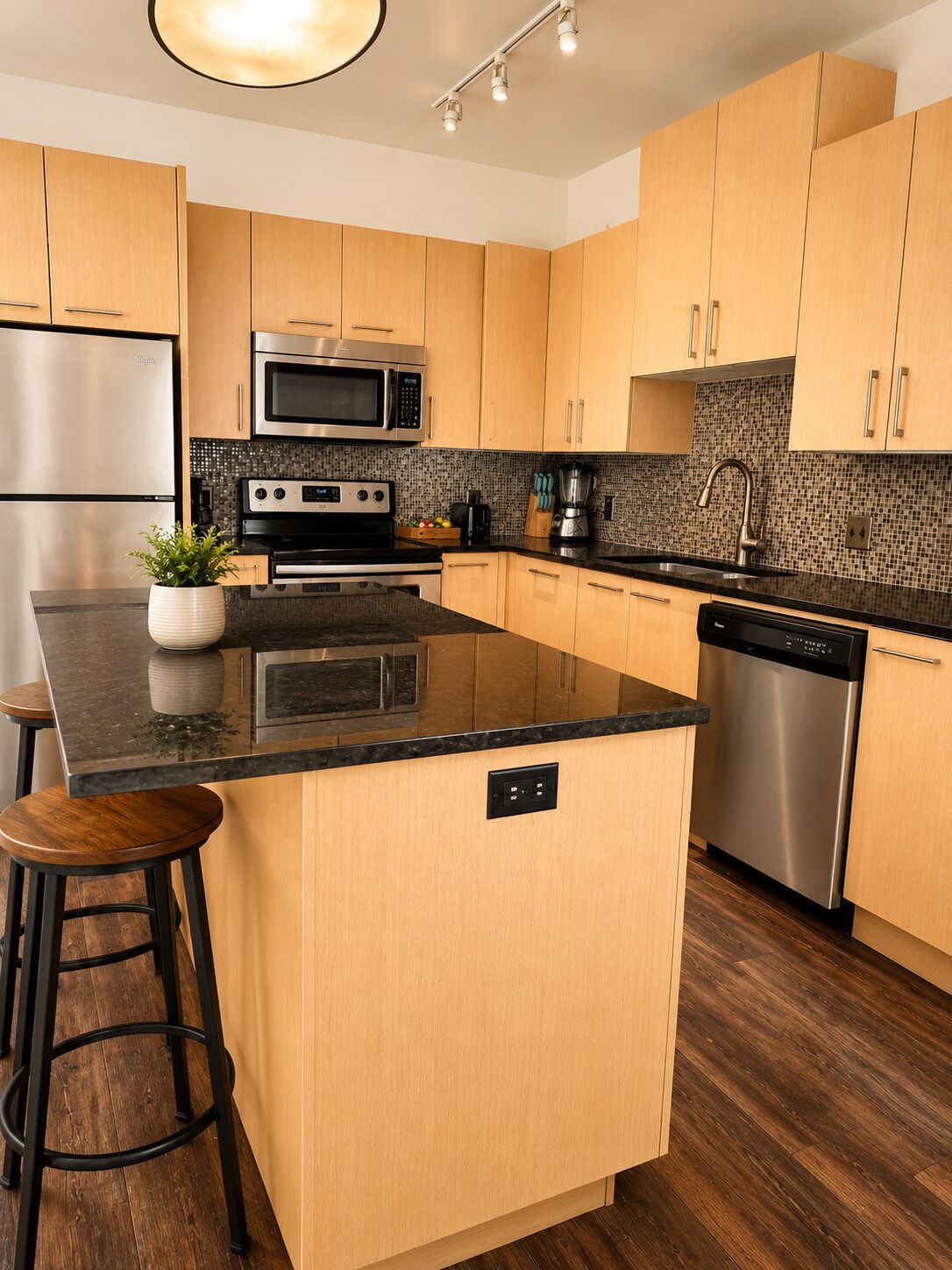 A modern kitchen with wooden cabinets, a stainless steel refrigerator, a microwave, a stove, and a dishwasher.