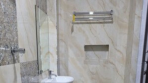 A bathroom with a sink, mirror, and a shower area. - Paisa Farm Stay (Pudunagar)