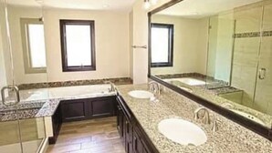 A bathroom with two sinks, a large mirror, and a shower area. - Warm, inviting condo 5 mins to Mt Snow. Dog-friendly, 2 fireplaces, Great wifi⛄️ (Wilmington)