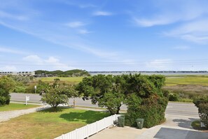 A residential area with a clear sky, a road, and a body of water in the distance. - Rest Coast Repeat-Just a short walk to the beach! (Atlantic Beach)