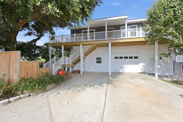 A two-story house with a covered porch and a garage. - Rest Coast Repeat-Just a short walk to the beach! (Atlantic Beach)