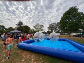A blue inflatable pool with two transparent spheres.