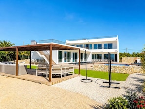 A modern two-story house with a covered outdoor seating area, a swimming pool, and a well-maintained garden. - Villa Carvoeiro, luxury 10 Bedroom, heated pool, games, BBQ (Carvoeiro)