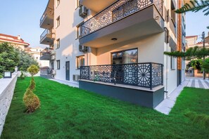 A multi-story residential building with a balcony featuring intricate metal railings. - Viranlar Residance (Fethiye)