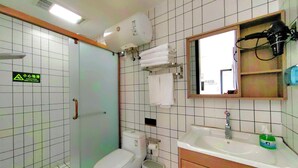 A bathroom with a toilet, sink, and mirror. There is a caution sign on the wall and a towel rack. - Mutianyu Great Wall View Lodge (Huairou)