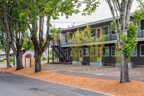 A modern building with a flat roof, multiple windows, and a staircase leading to an upper level. - Extended Stay Apt #12 • 1 BD-Full Kitchen • Downtown McMinnville (McMinnville)