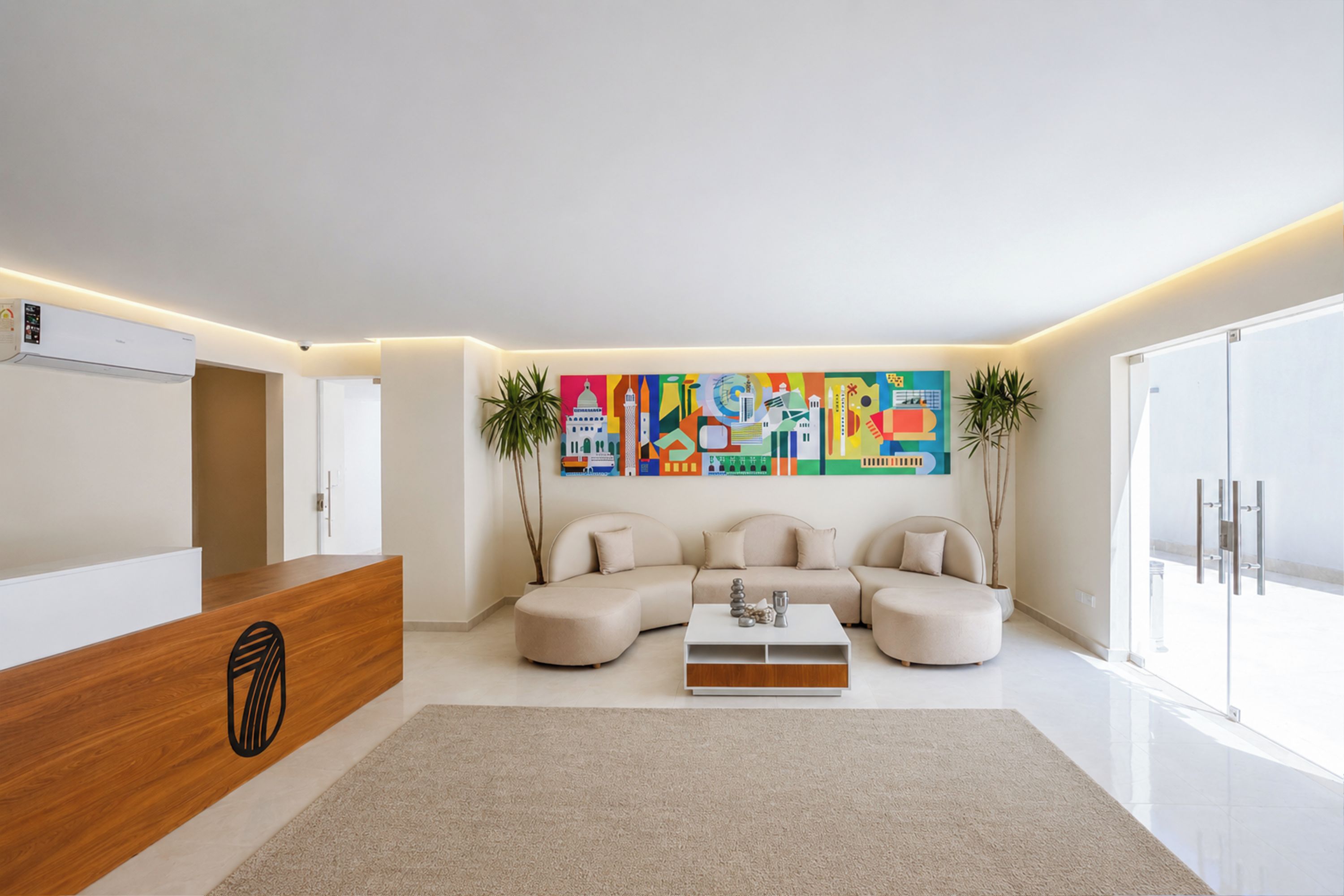 A modern living room with a sectional sofa, a coffee table, and a large abstract painting on the wall.