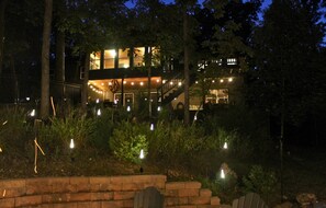 A multi-level building with outdoor lighting and a staircase leading to the upper levels. - Luxurious Lakefront House on Private Lake Lorraine near all Innsbrook Amenities! (Innsbrook)