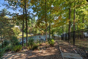 A park with a walking path, benches, a fence, and trees. - Luxurious Lakefront House on Private Lake Lorraine near all Innsbrook Amenities! (Innsbrook)