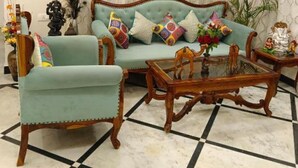 Una sala de estar con sofá, sillones y una mesa de centro.