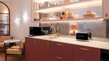 A modern kitchen with a built-in island, stainless steel appliances, and a glass-top dining table.