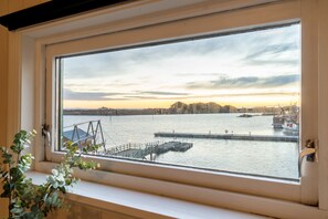 A view through a window of a waterfront area with a dock and boats.