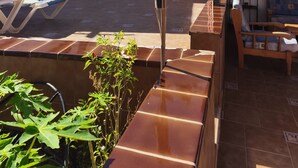 A courtyard with a basketball hoop, a bench, and a small table. - STAR OF THE SOUTH (Valle La Lajita)