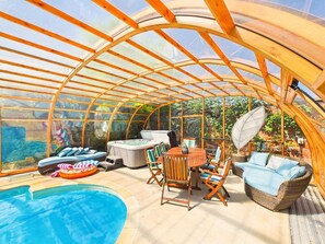 A covered outdoor area with a pool, seating, and hot tubs. - The Hyde | Private Hot tub & Pool | Modern (Prestbury)