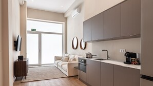 A modern kitchen with a built-in oven, a coffee machine, and a sink. - Waou Madrid Rio II - Short-Term Rental (Madrid)