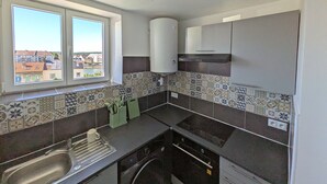 A compact kitchen with a window, a built-in oven, and a sink. - Creil 10 min · Paris, CDG 25 min · Asterix 20 min · JW Assembly 2 min (Creil)