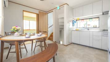 A modern kitchen with white cabinets, a built-in oven, and a window with a view.