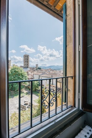 A balcony with a metal railing overlooking a cityscape with historic buildings and a clear sky. - Palace d'Art - Historic Center of Arezzo (Arezzo)