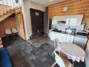 A modern kitchen with white cabinets, a built-in microwave, and a stove. - Tranquil 1-bedroom cottage perfect for a relaxing getaway (Unknown)
