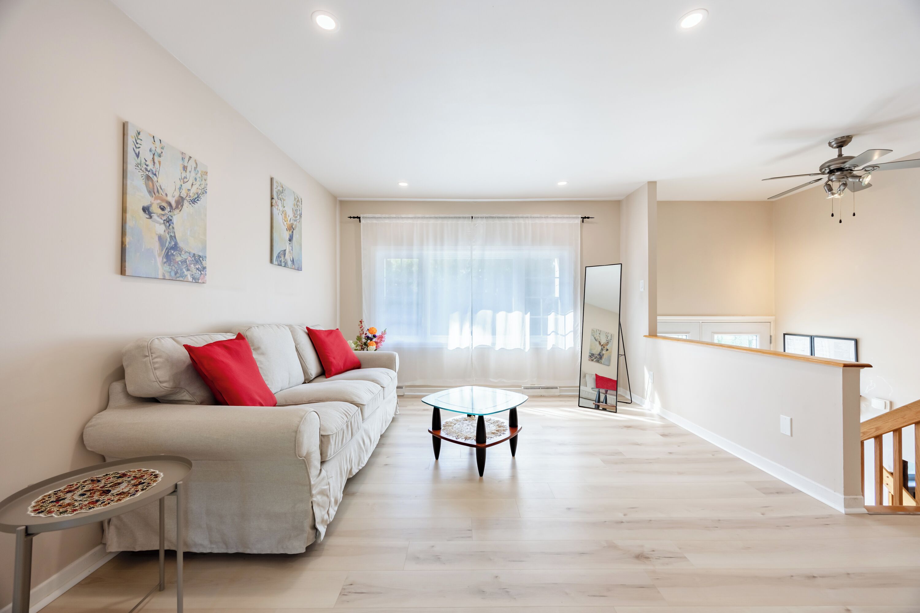 A spacious living area with a sofa, a coffee table, and a dining table.