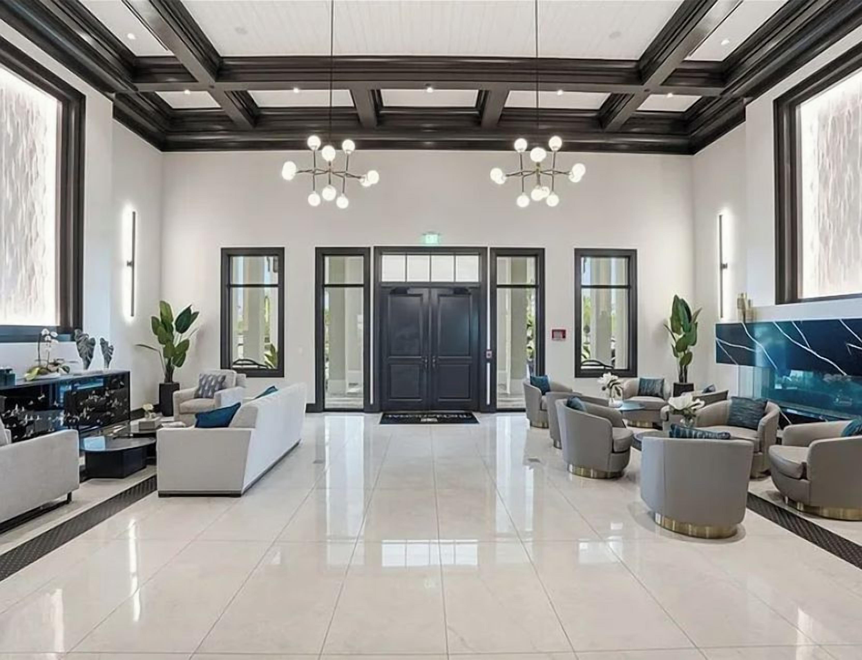 Step into a sophisticated lobby where elegant coffered ceilings and modern chandeliers create an inviting first impression. Plush seating areas and sleek finishes set the tone for your refined getaway.