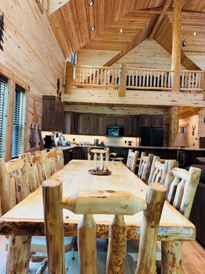 A spacious wooden dining area with a high ceiling and a balcony overlooking the kitchen. - Deer Creek Lodge -12 min. to YNP+Hot tub+AC+Sauna Sleeps 26 (Island Park)