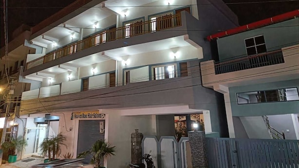 A multi-story building with balconies, a visible storefront, and a gated entrance. - Hotel Deewan Saray (Haldwani)