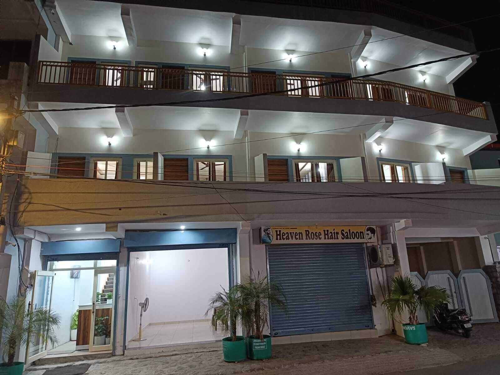 A multi-story building with a commercial ground floor featuring a hair salon.