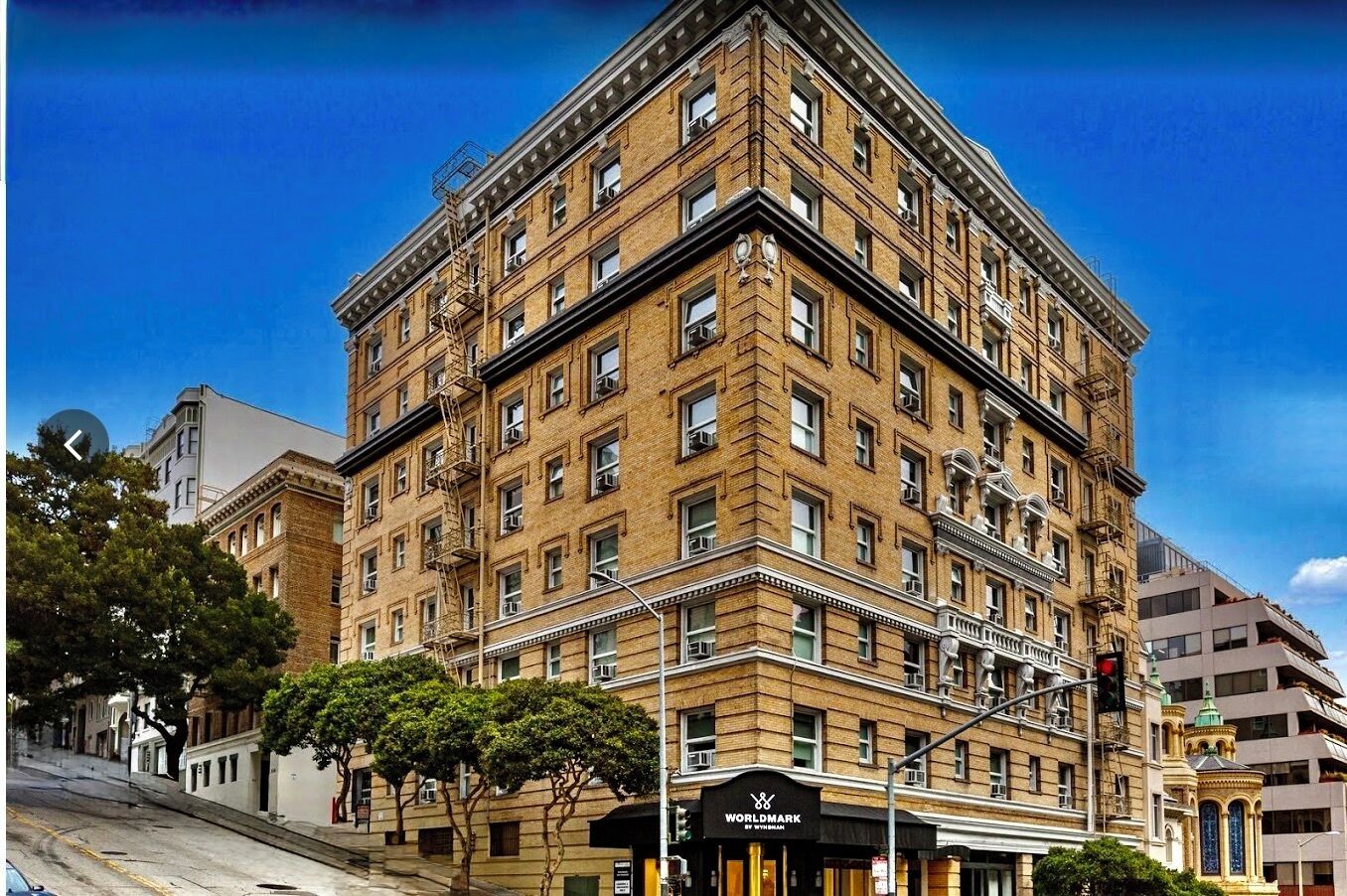 A multi-story building with a corner entrance, large windows, and a sign for 'WORLDMARK by BARNETT.'