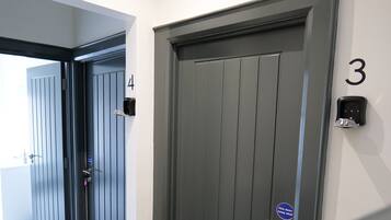 A hotel entrance with two doors, one marked with the number 3 and the other with the number 4.