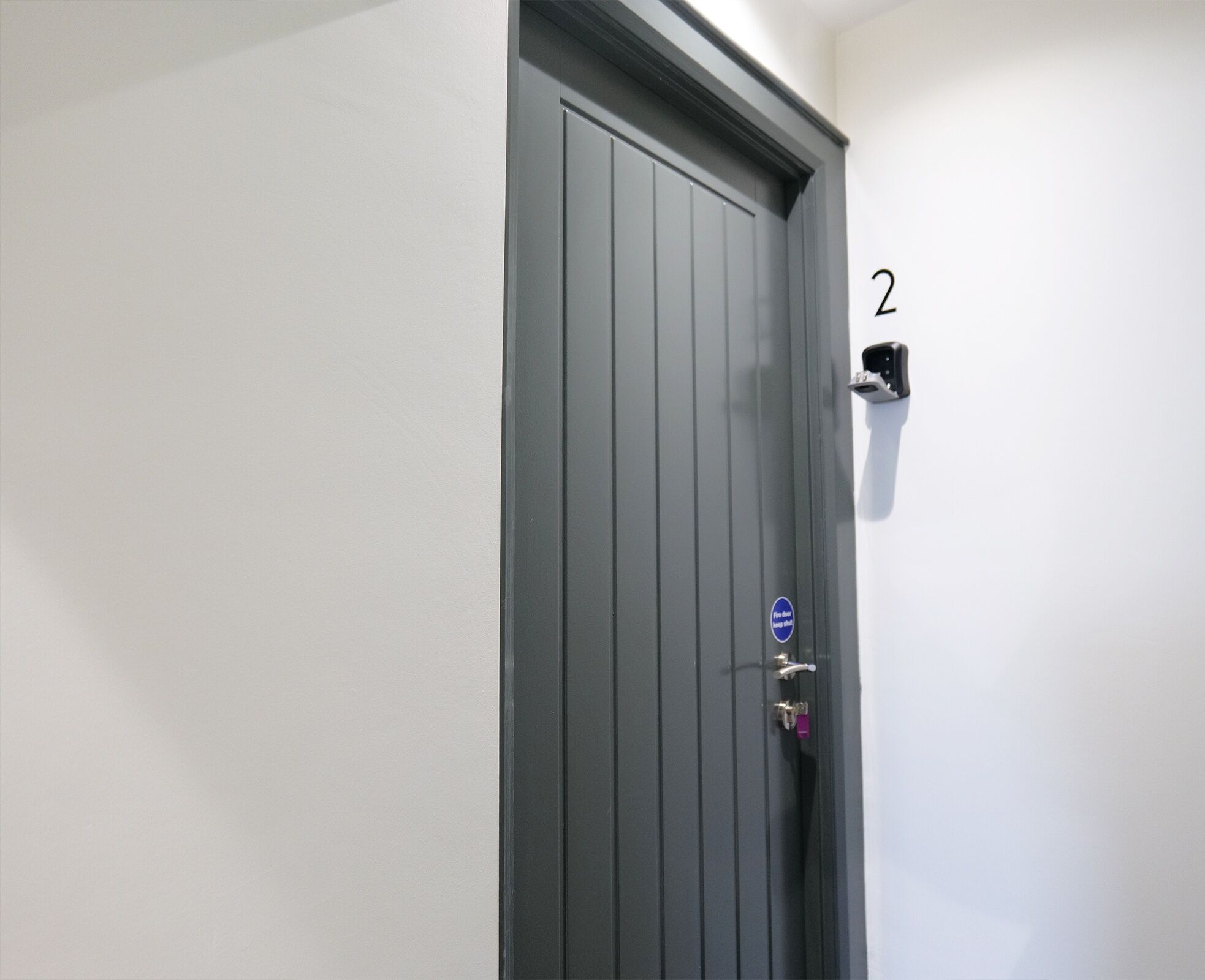 A door with a number '2' on the wall beside it.