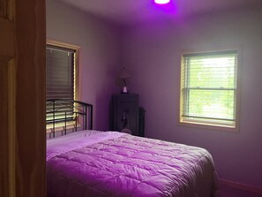 A bedroom with a bed, a dresser, and a window. - Enjoyable 2-bedroom cabin with AC in Crivitz near the high Falls flowage (Crivitz)