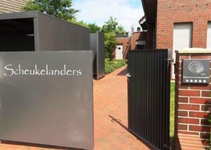 A gated entrance with a sign reading "Scheukelanders." - Discover the Scheukelanders Oasis! (Borkum)