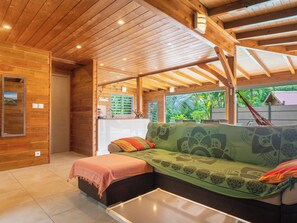 A wooden interior with a sofa, a small table, and a bench. - 3-star Villa Terrasses de Saint Protais with an unobstructed view of the country (Sainte-Anne)