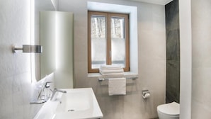 A modern bathroom with a large sink, a toilet, and a window above the sink. - Auberge de morcles (Lavey-Morcles)