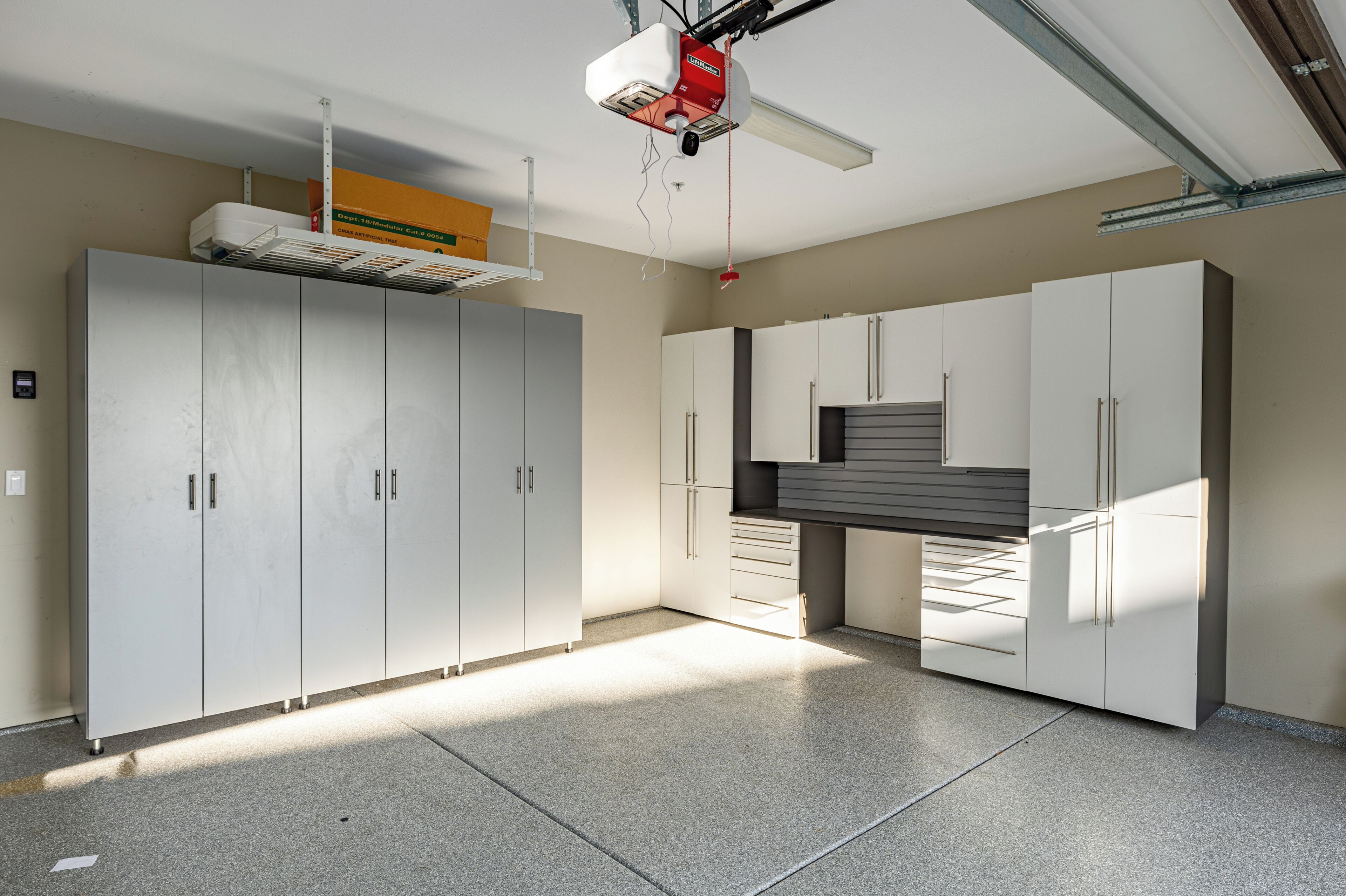 A spacious room with large cabinets, a ceiling fan, and a visible ductwork system.